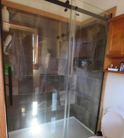 Photo 619_5297.jpg - Both full baths offer tile surrounds and glass doors.