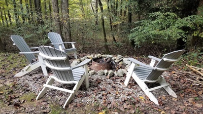 Photo 619_5302.jpg - Fire pit is tucked into the woods and has comfortable seating