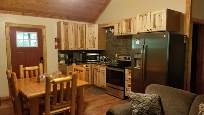Photo 619_6333.jpg - Love this kitchen and dining!  Hickory cabinets, new stainless appliances, log furniture, traditional and keurig coffee makers
