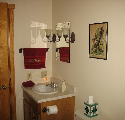 Photo 626_1553.jpg - Vanity with etched mirror and wall sconces